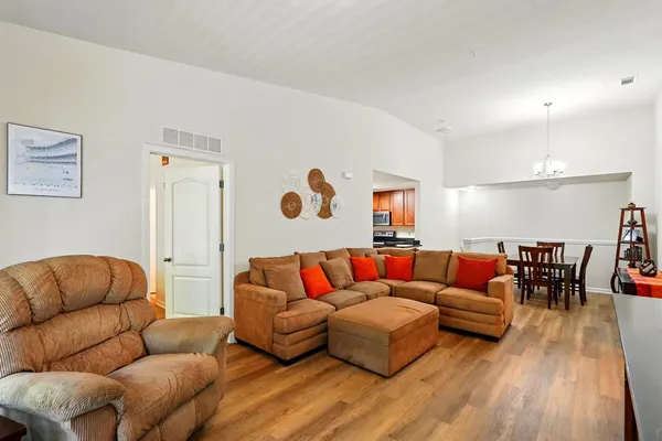 a kitchen with granite countertop stainless steel appliances a refrigerator stove top oven and sink