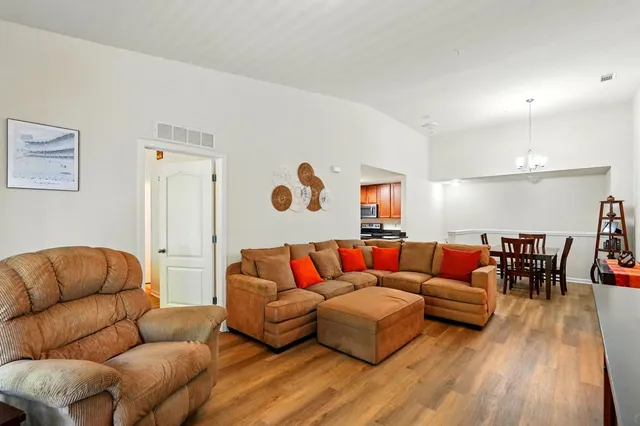 a kitchen with granite countertop stainless steel appliances a refrigerator stove top oven and sink