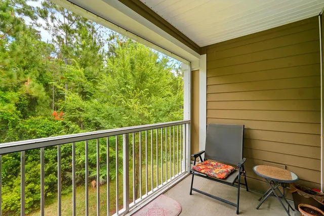 a view of a porch with a door and wooden floor