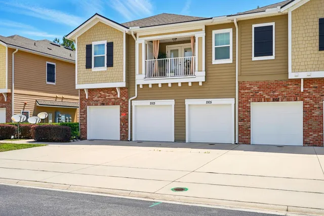 a front view of a house with garage
