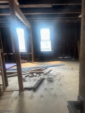 a view of a hallway with wooden floor and stairs