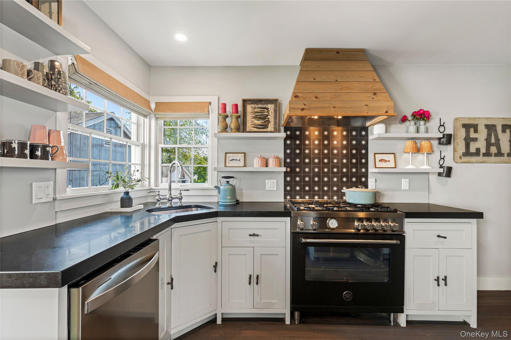 321 Rye Beach Avenue Rye, NY 10580 - Photo 17 of 36 Kitchen with open shelves, high end black range, custom exhaust hood, white cabinets, and dishwasher