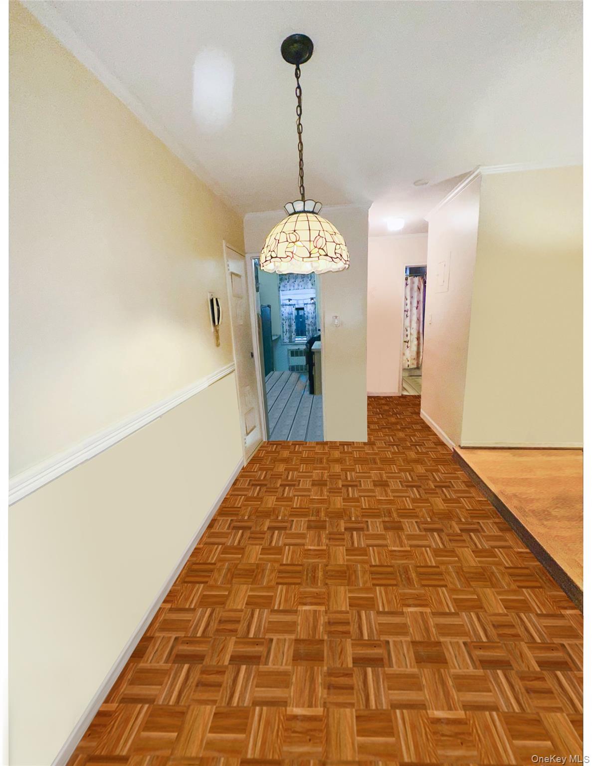 222-89 Braddock Avenue, Unit 1G Queens, NY 11428 - Photo 4 of 13 a very nice looking room with a chandelier