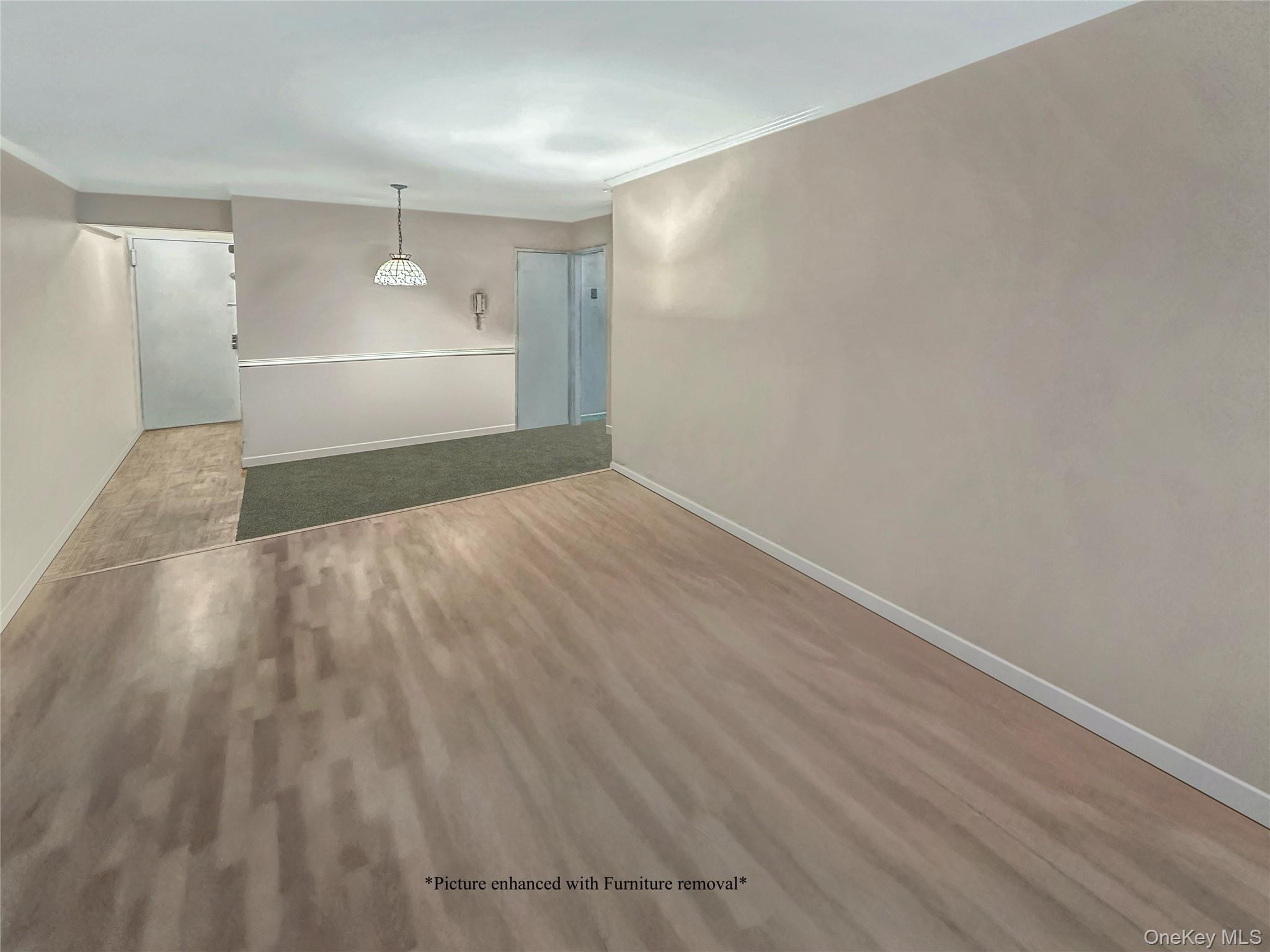 222-89 Braddock Avenue, Unit 1G Queens, NY 11428 - Photo 5 of 13 a view of empty room with wooden floor