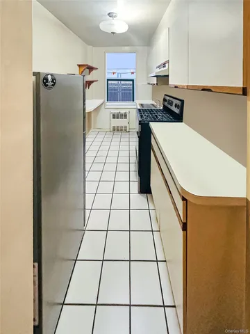 a kitchen with stainless steel appliances a refrigerator sink and cabinets