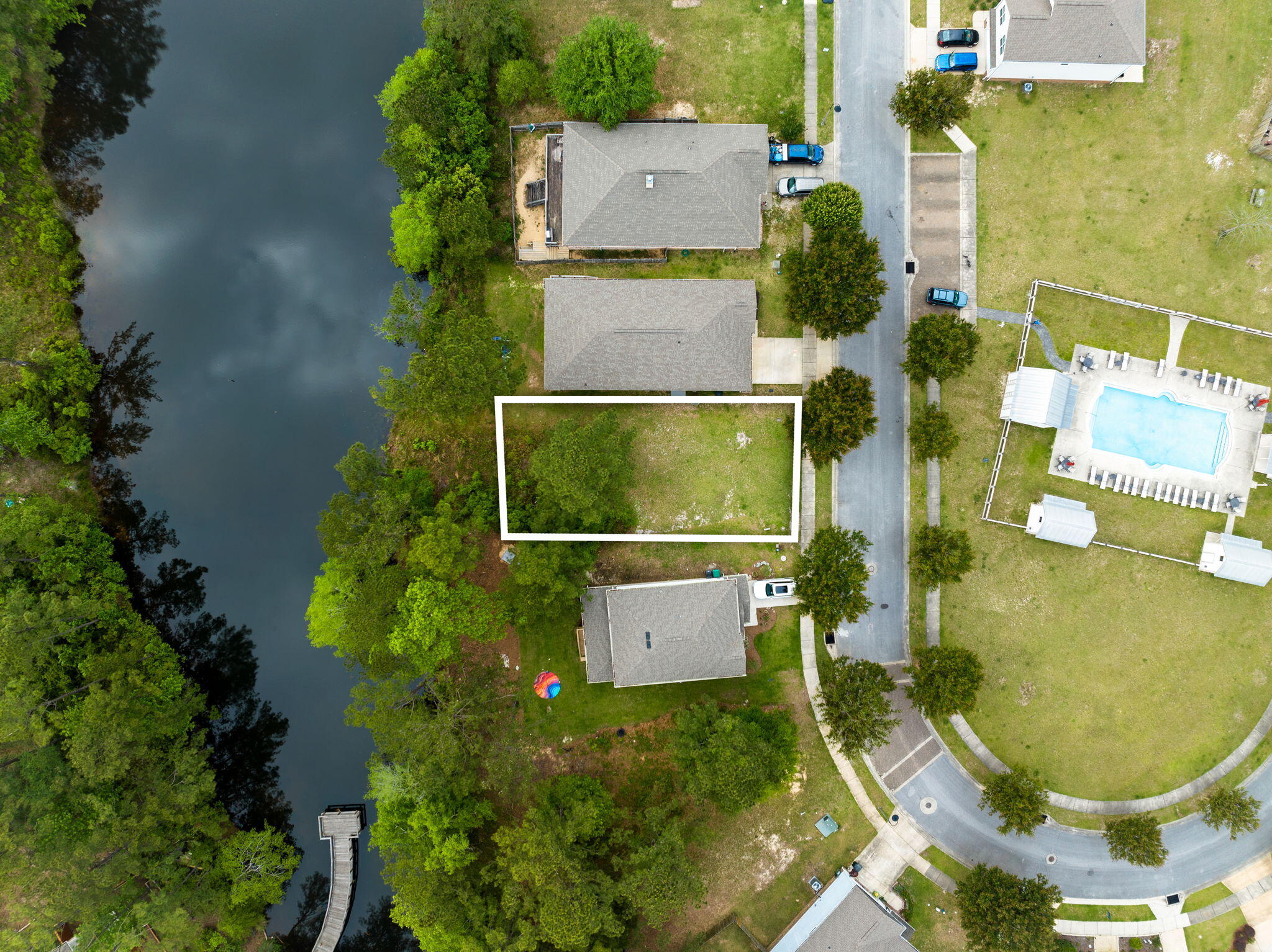 an aerial view of a residential houses with outdoor space and street view