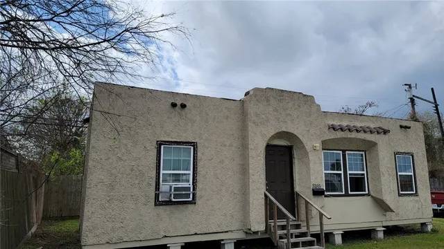 a front view of a house with large windows