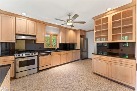 a living room with a white bed and a chandelier