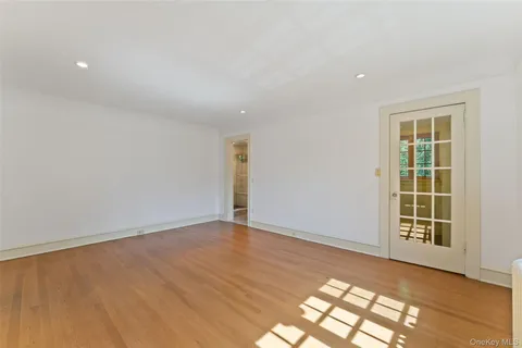 a view of a room with a window and wooden floor