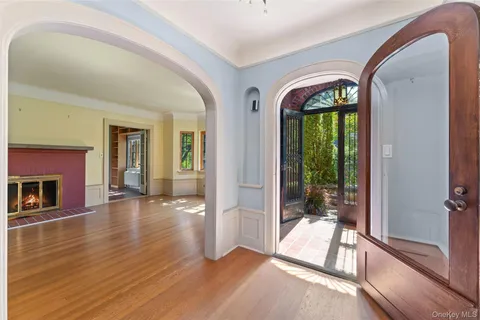 a view of empty room with wooden floor and fireplace