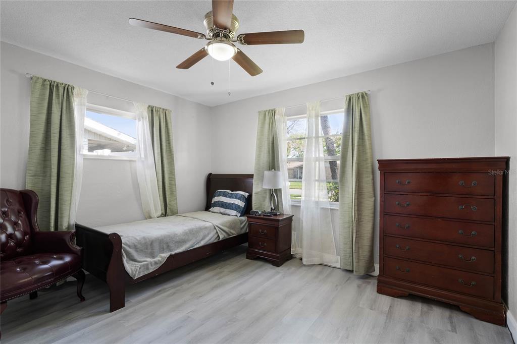 1312 Mardrake Road Daytona Beach, FL 32114 - Photo 21 of 33 a bedroom with a bed and a chandelier