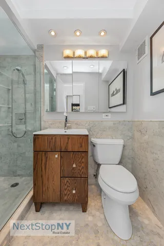a bathroom with a toilet sink and mirror