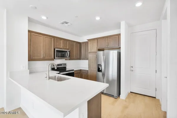 a kitchen with a refrigerator sink and stove