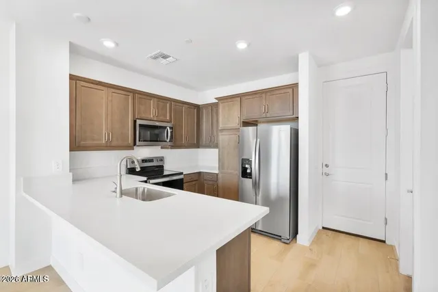 a kitchen with a refrigerator sink and stove