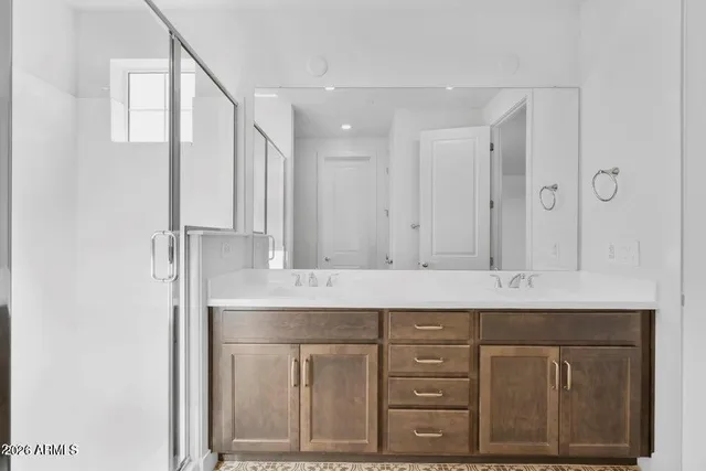 a bathroom with a double vanity sink and a mirror