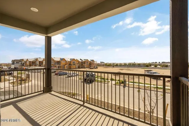 a row of palm trees in front of a house