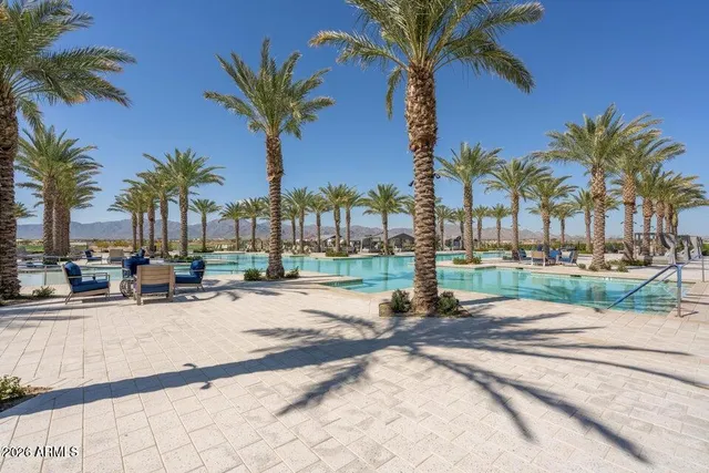 a view of a swimming pool and a longer chairs