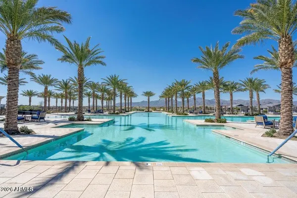 a swimming pool with outdoor seating yard and lake view