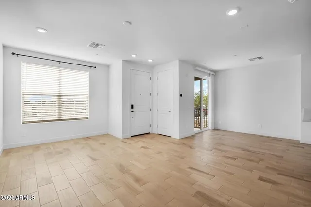 an empty room with windows and closet