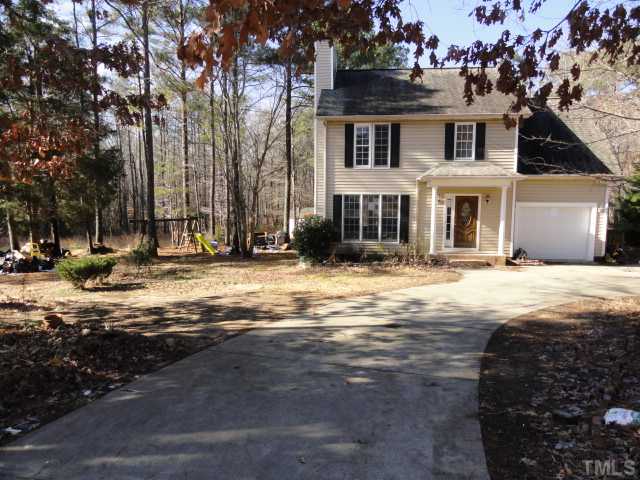9341 Woodlief Road Wake Forest, NC 27587 - Photo 1 of 10 a front view of a house with a yard