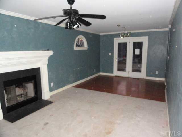 9341 Woodlief Road Wake Forest, NC 27587 - Photo 2 of 10 a view of an empty room with a fireplace