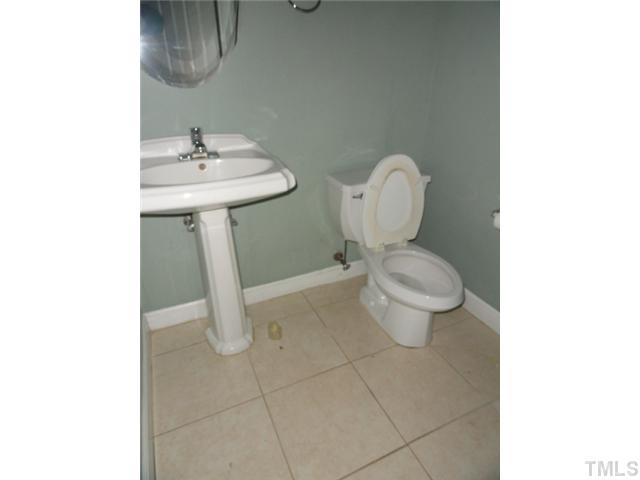 9341 Woodlief Road Wake Forest, NC 27587 - Photo 4 of 10 a bathroom with a toilet sink and mirror