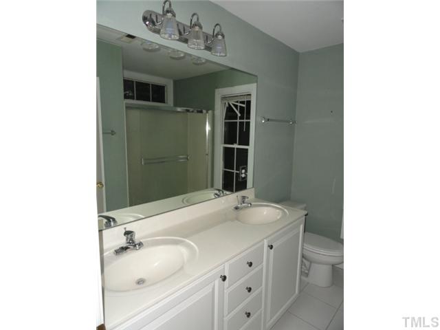 9341 Woodlief Road Wake Forest, NC 27587 - Photo 6 of 10 a bathroom with a sink and a mirror
