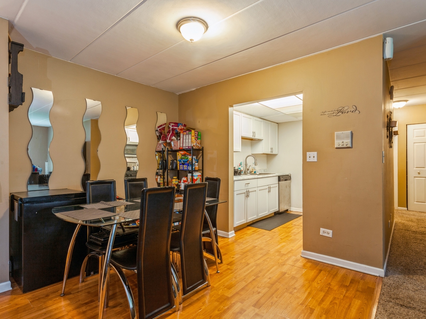 244 East Bailey Road, Unit H Naperville, IL 60565 - Photo 3 of 9 a view of a dining room with furniture and chandelier