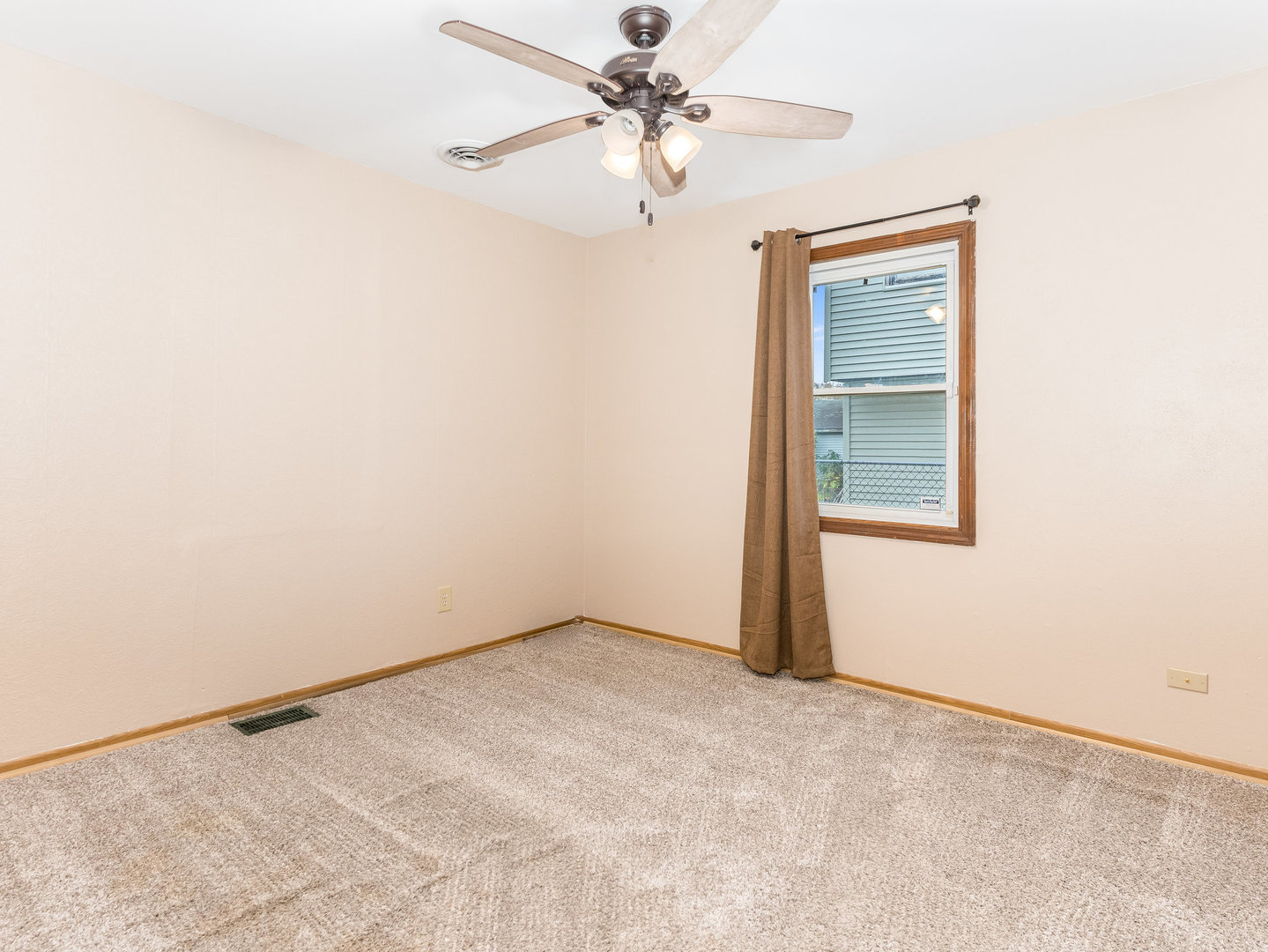 205 Luana Road Joliet, IL 60433 - Photo 11 of 13 an empty room with a ceiling fan and a window