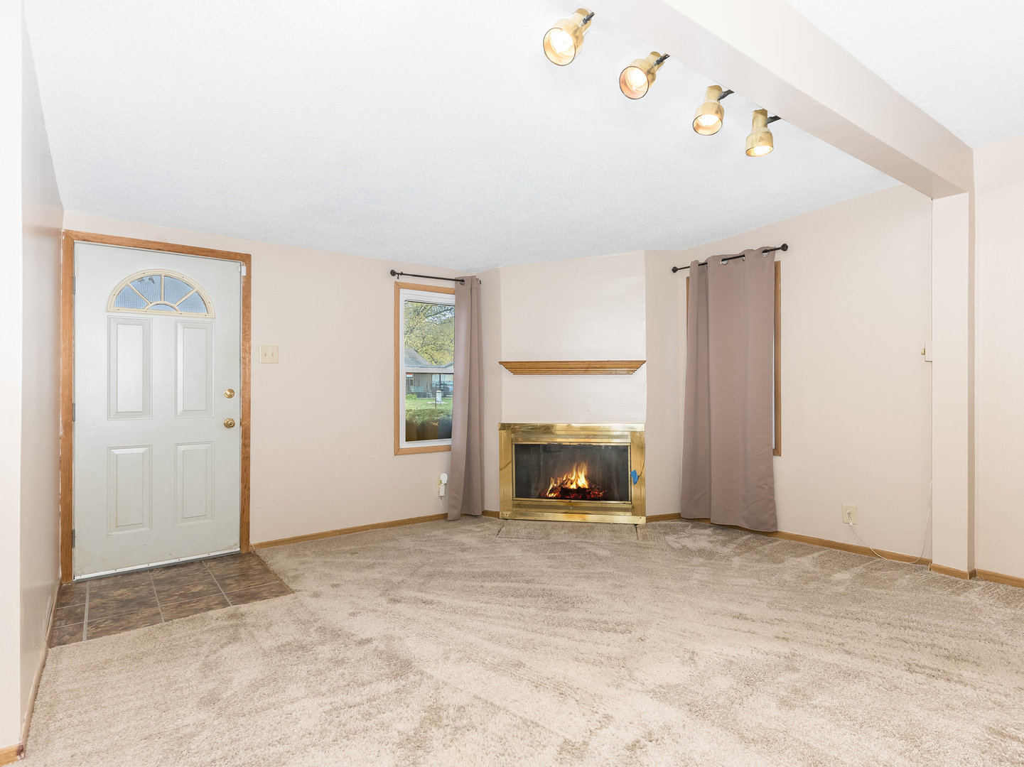 205 Luana Road Joliet, IL 60433 - Photo 3 of 13 a view of an empty room with a fireplace