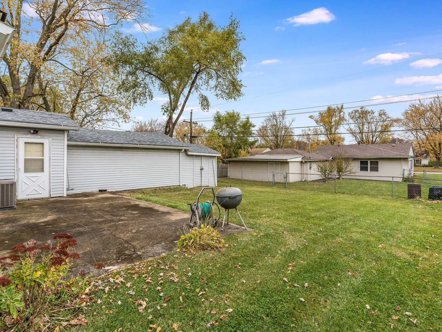 205 Luana Road Joliet, IL 60433 - Photo 8 of 13 a backyard of a house with table and chairs