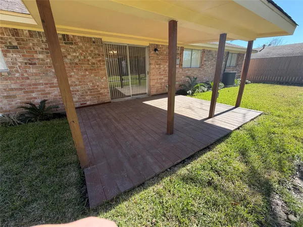a view of a yard with wooden fence