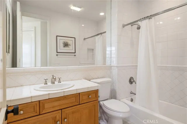a bathroom with a sink toilet vanity and shower