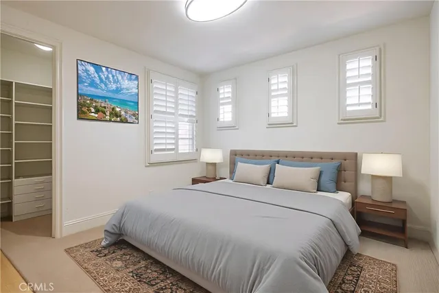 a bedroom with a bed and a night stand