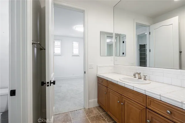a bathroom with a granite countertop sink mirror and double