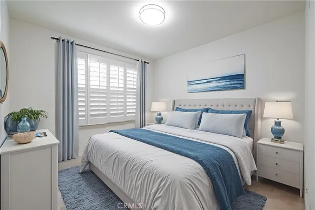 a bedroom with a large bed and a potted plant