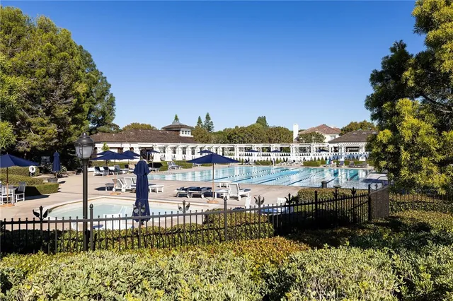 a view of a lake with a building and trees in the background