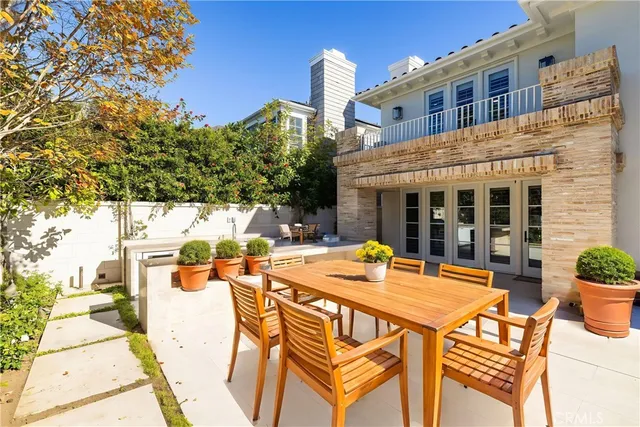 a view of a patio with table and chairs and potted plants