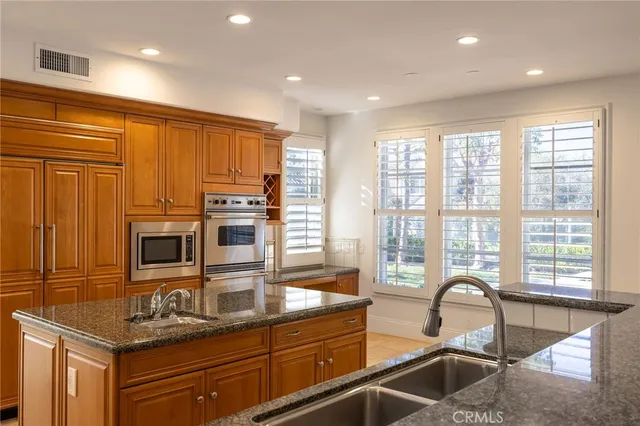 a kitchen with a sink a counter cabinets and appliances