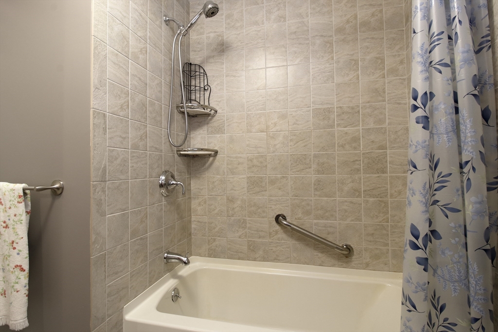 130 Massey Road Tiverton, RI 02878 - Photo 11 of 16 a bath tub sitting next to a white sink and a shower