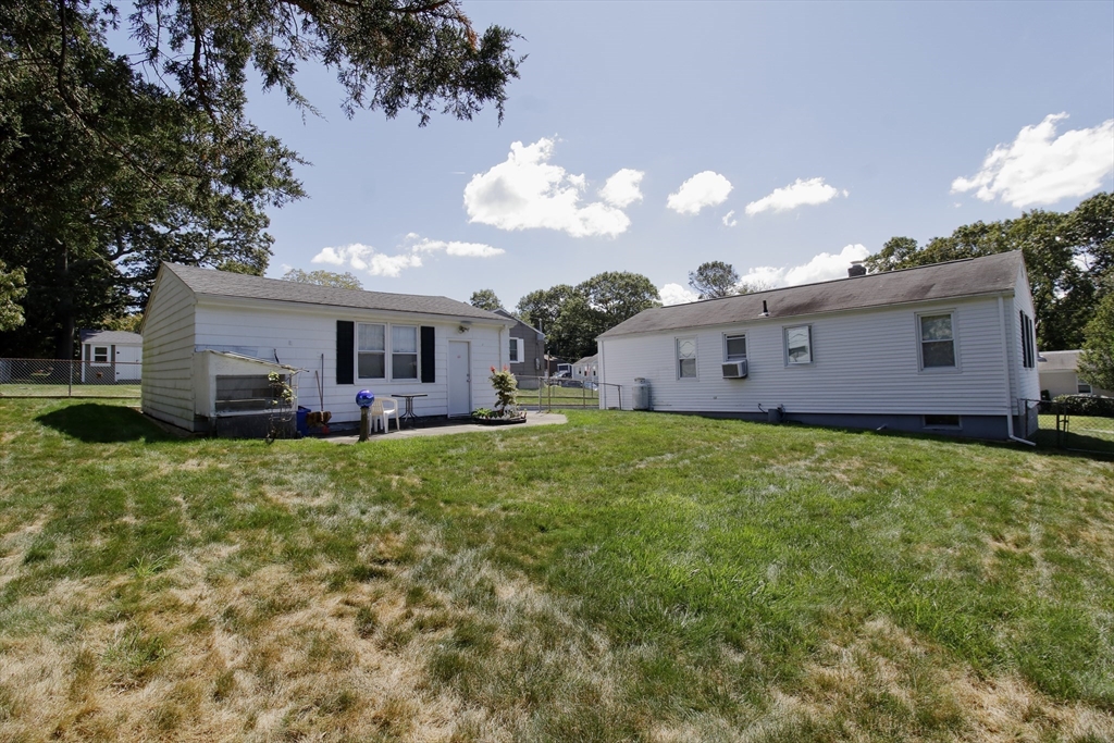 130 Massey Road Tiverton, RI 02878 - Photo 5 of 16 a view of a house with a big yard and large trees