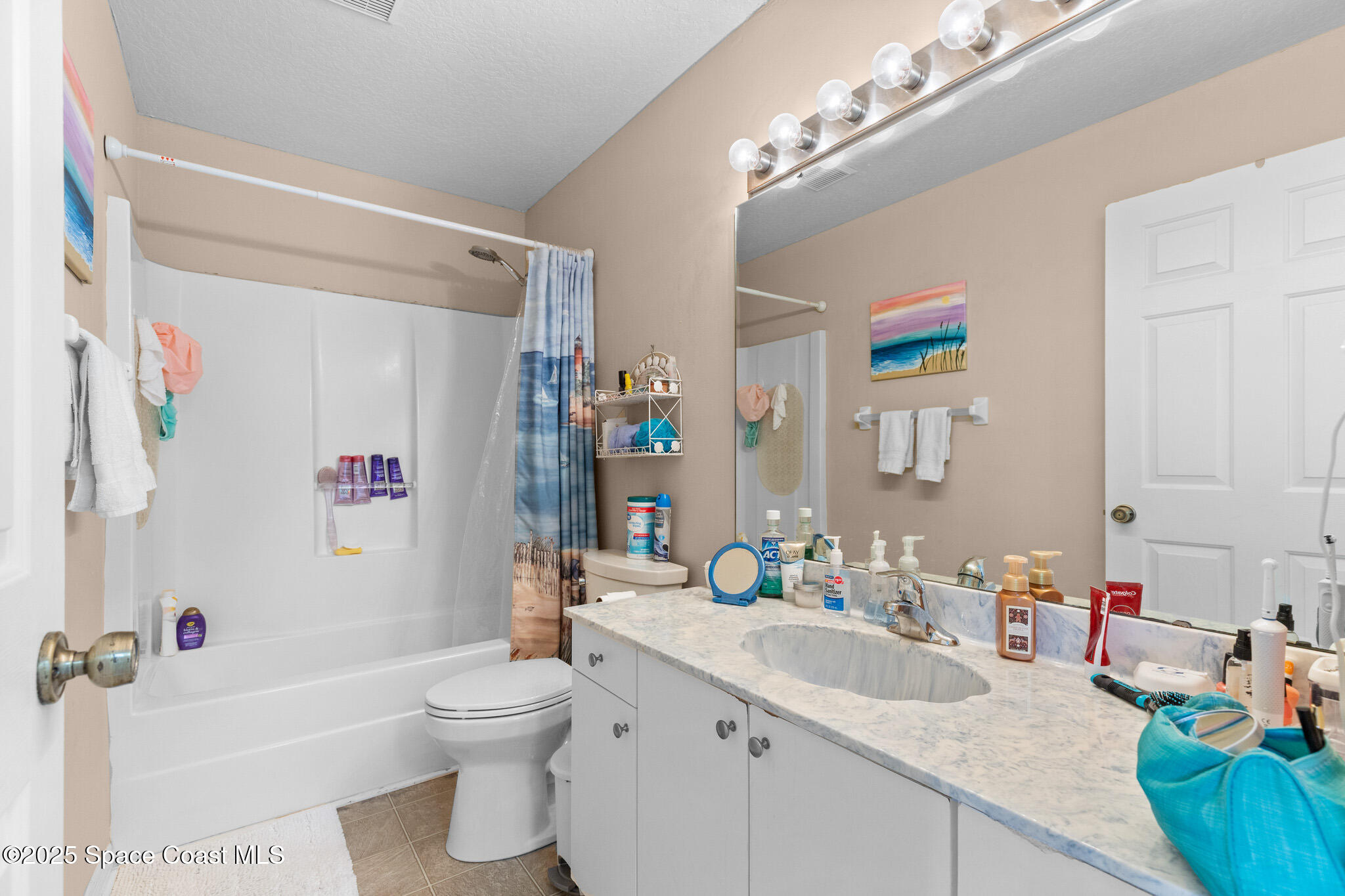 243 Forecast Lane, Unit 421 Rockledge, FL 32955 - Photo 11 of 43 a bathroom with a sink a toilet and a large mirror