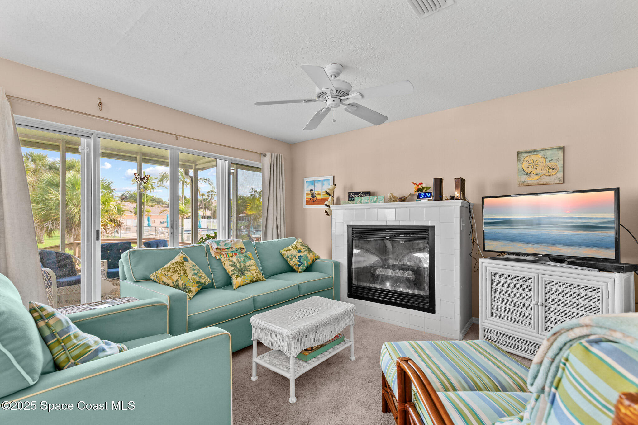 243 Forecast Lane, Unit 421 Rockledge, FL 32955 - Photo 19 of 43 a living room with furniture a flat screen tv and a fireplace