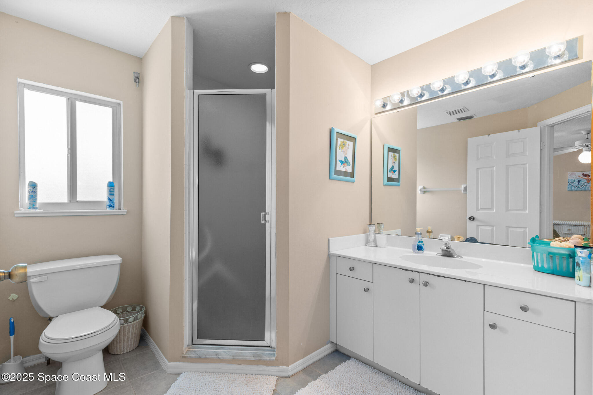 243 Forecast Lane, Unit 421 Rockledge, FL 32955 - Photo 22 of 43 a bathroom with a toilet sink and mirror