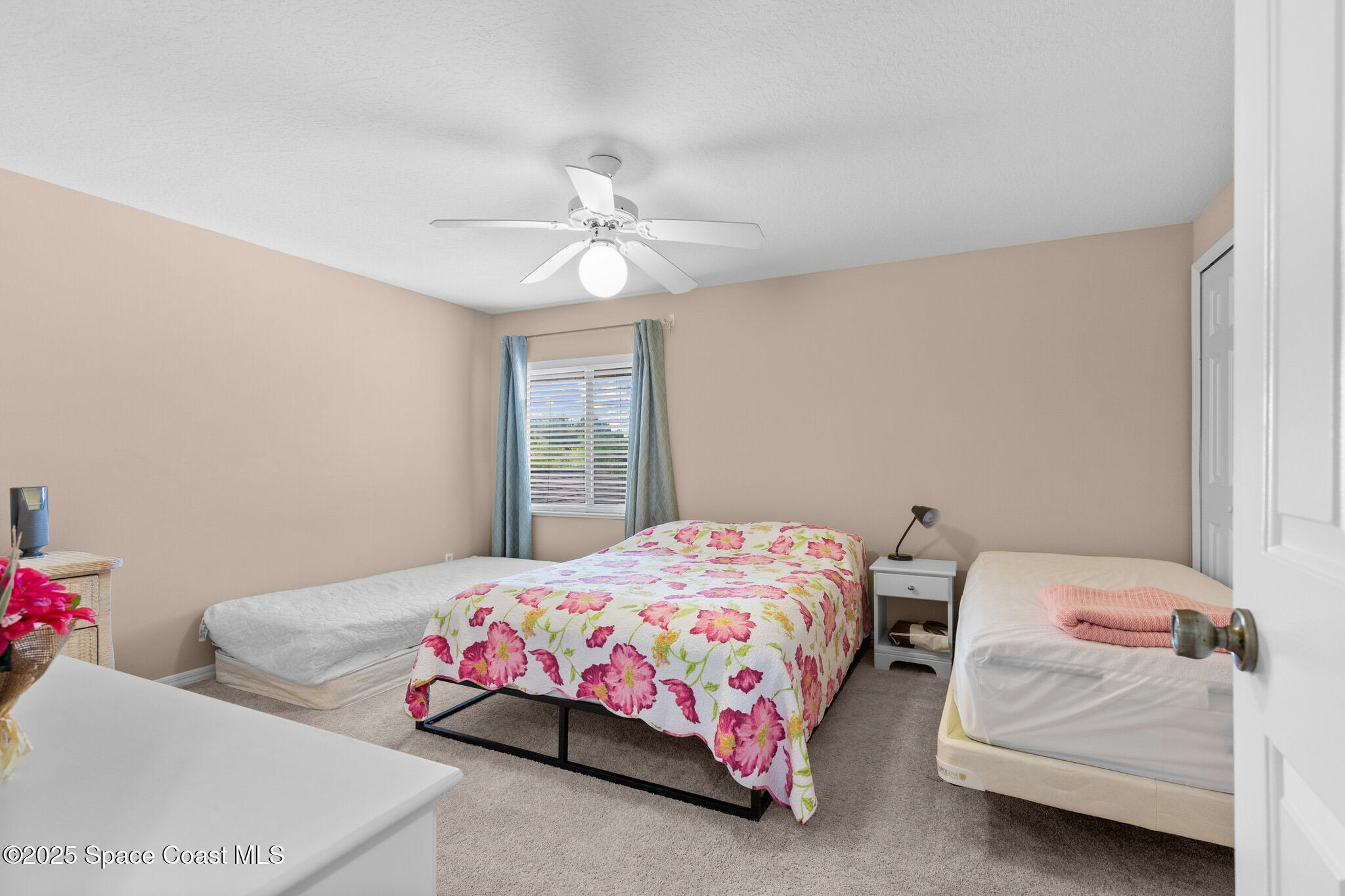 243 Forecast Lane, Unit 421 Rockledge, FL 32955 - Photo 23 of 43 a bedroom with two beds and a chandelier