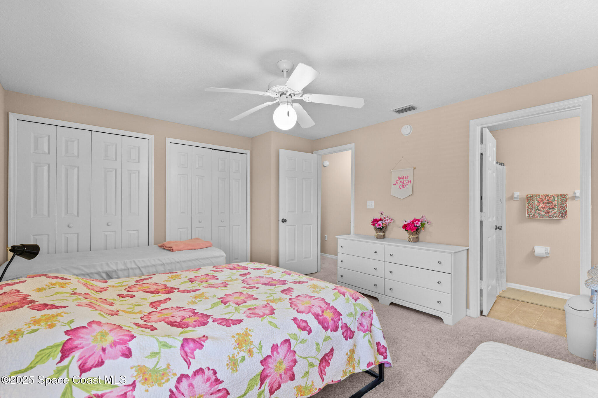 243 Forecast Lane, Unit 421 Rockledge, FL 32955 - Photo 24 of 43 a bedroom with a bed chandelier and a closet