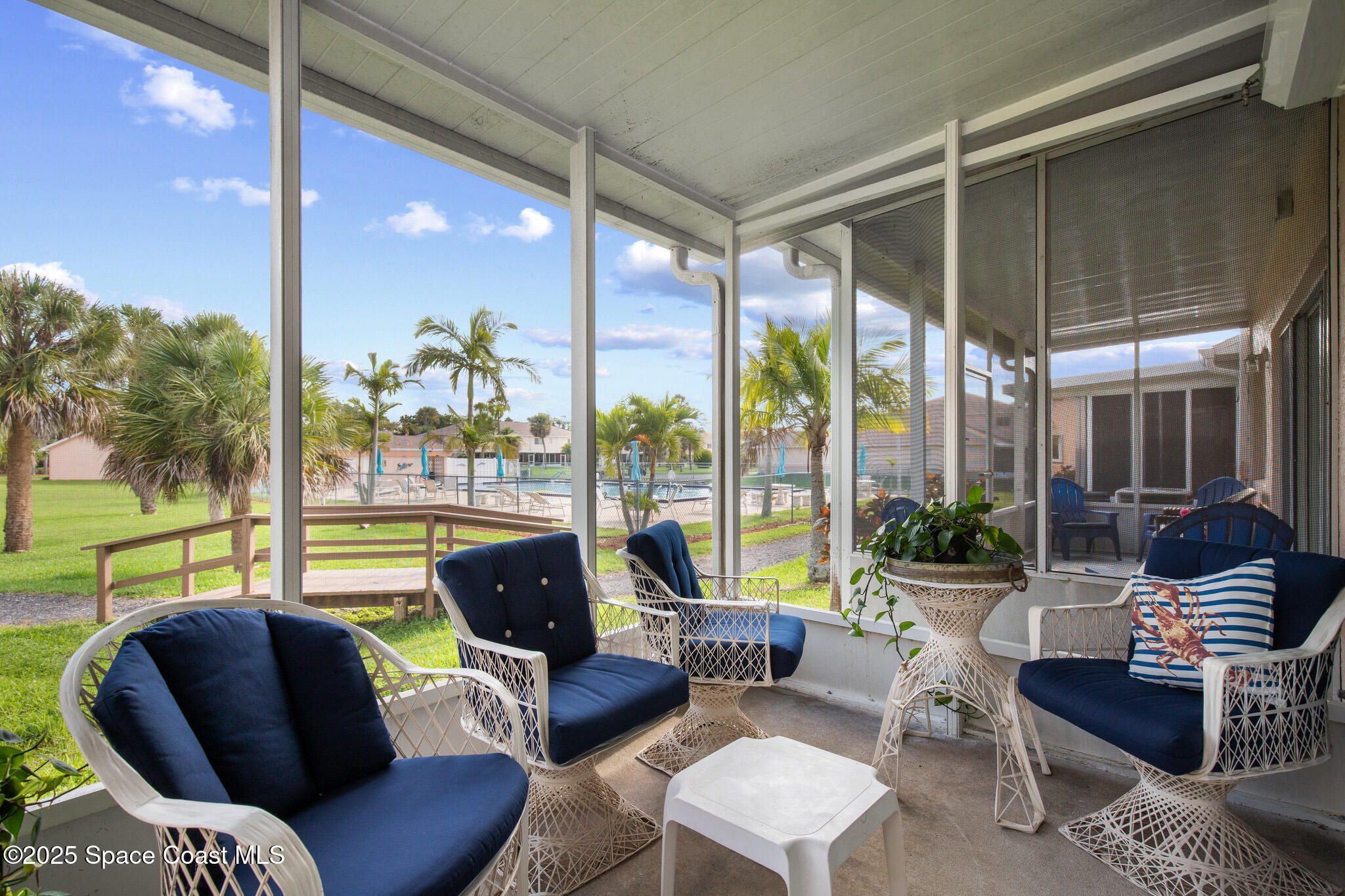 243 Forecast Lane, Unit 421 Rockledge, FL 32955 - Photo 27 of 43 a living room with furniture and a floor to ceiling window
