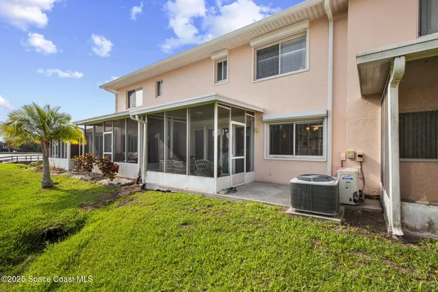 a view of a house with backyard sitting area and garden