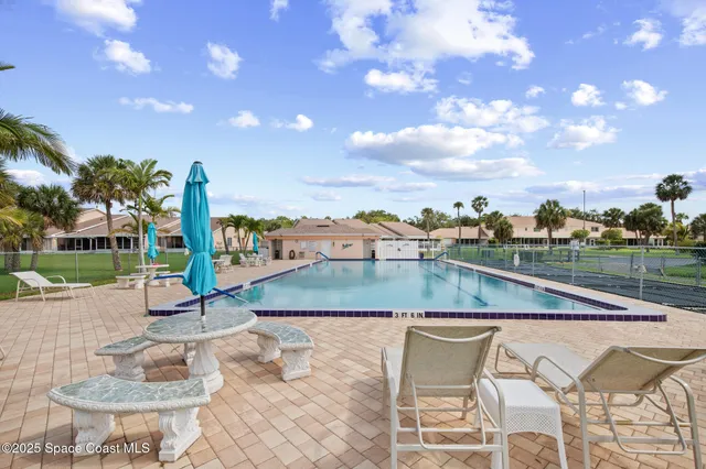 a view of swimming pool with seating area and barbeque oven