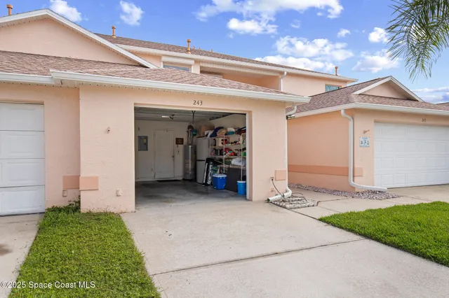 a view of a house with a yard and garage